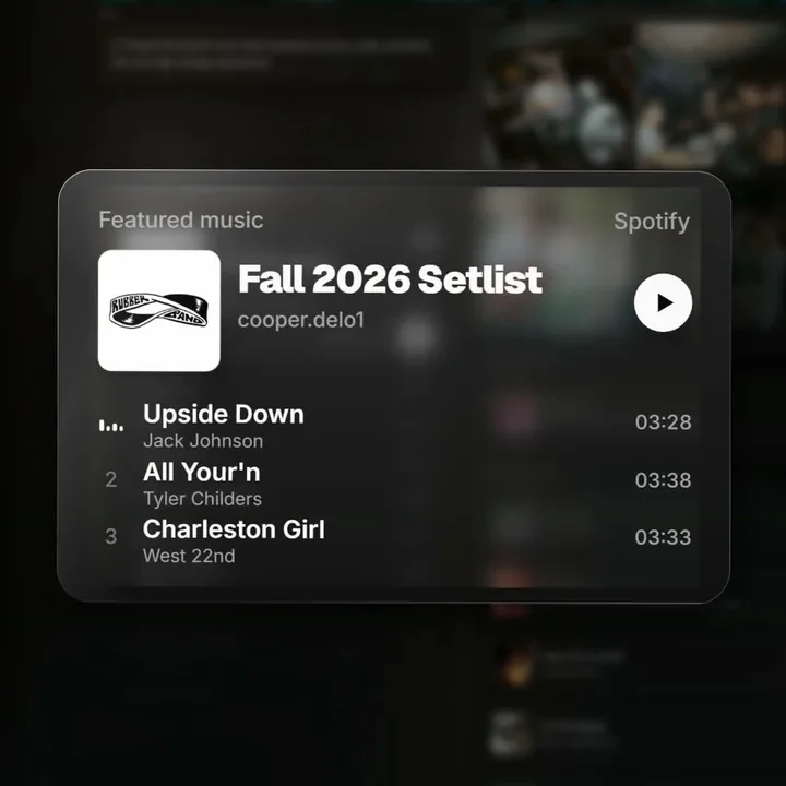 A frame from Bioswap: a glass music card floating over a blurred band page