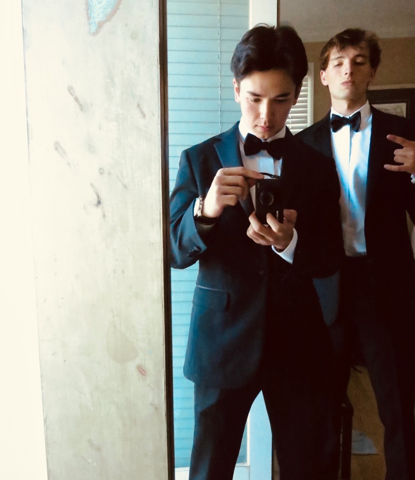 Cooper in tuxedo holding Canon S100