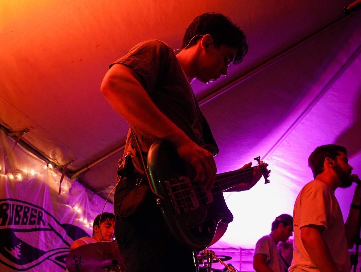 Rubber Band tent gig in purple lighting