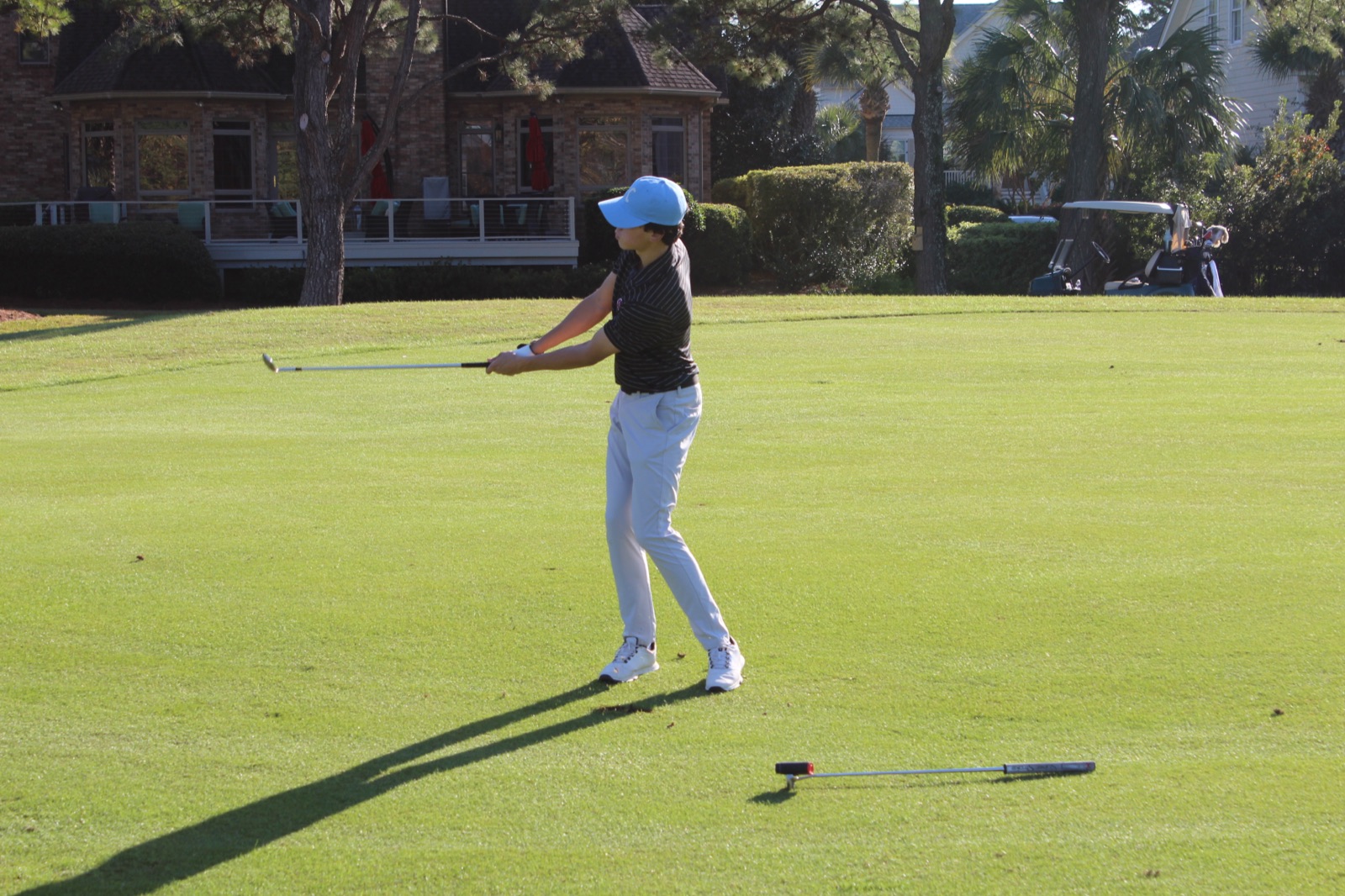 Cooper finishing swing on the green